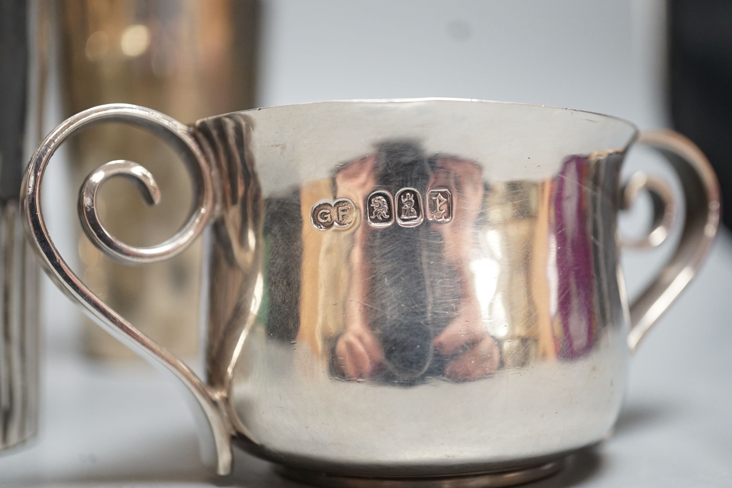 A George III engraved silver goblet, maker's mark rubbed, London, 1784, 14.6cm, together with an Edwardian silver tea caddy, a Victorian goblet, silver beaker and Brittania standard two-handle bowl by George Perkins, Lon